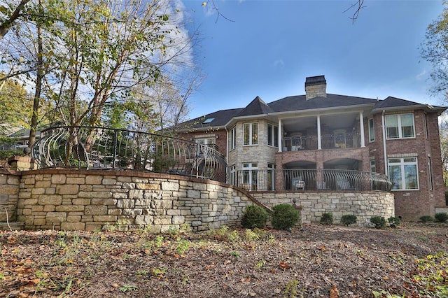 rear view of property with a balcony