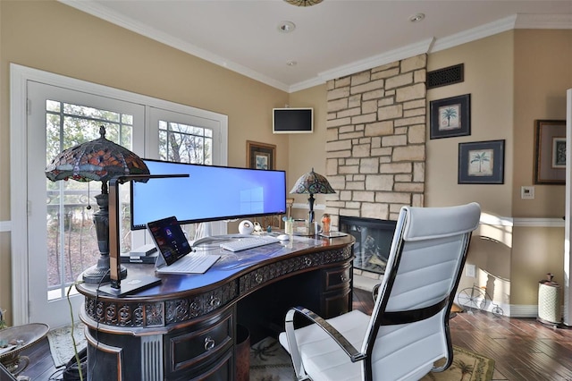 office space featuring dark hardwood / wood-style floors, a stone fireplace, and ornamental molding