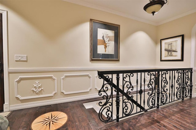 stairs with hardwood / wood-style flooring and crown molding