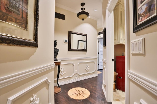 corridor with hardwood / wood-style flooring and ornamental molding