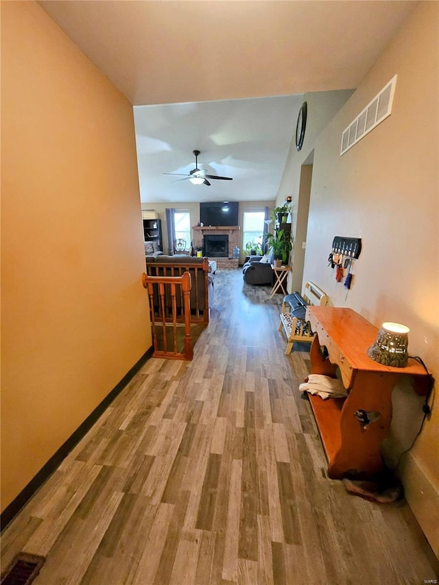 hallway with hardwood / wood-style flooring