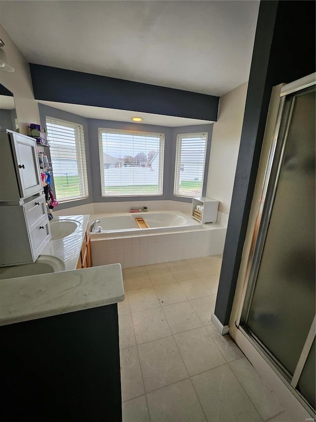 bathroom with tile patterned flooring, shower with separate bathtub, and vanity