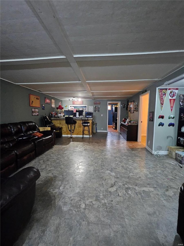 living room with bar area and concrete floors