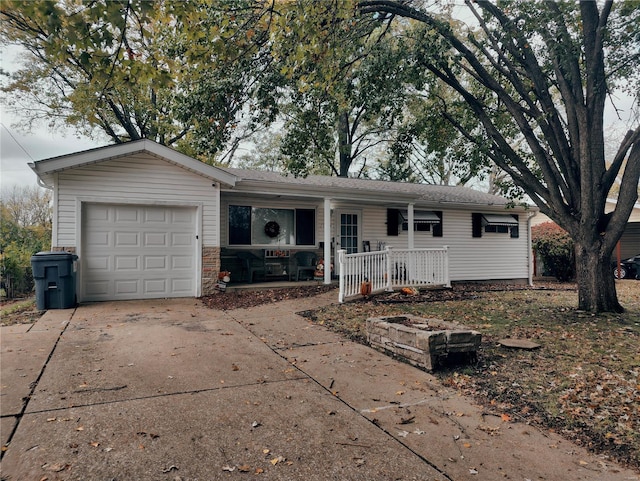 ranch-style home featuring a garage and covered porch