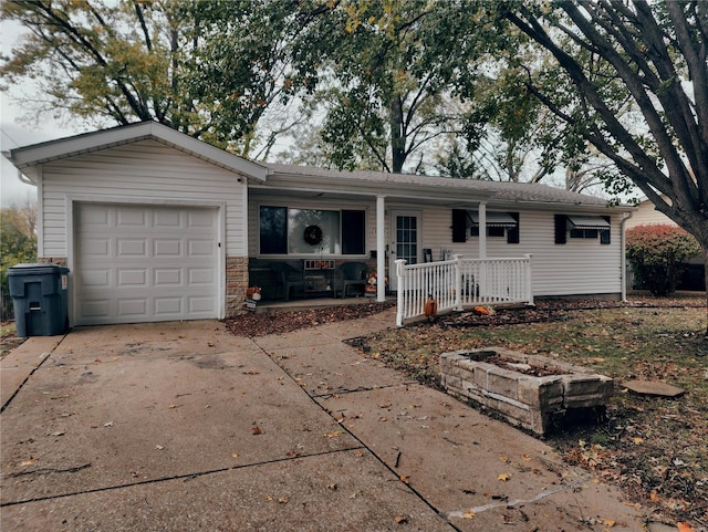 ranch-style home featuring a garage and covered porch