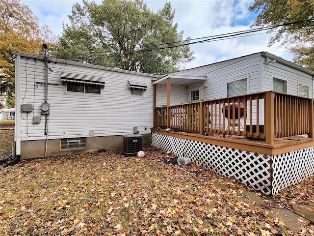 back of property featuring a wooden deck and central AC