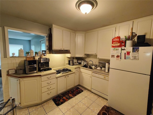 kitchen featuring white cabinetry, white appliances, and backsplash