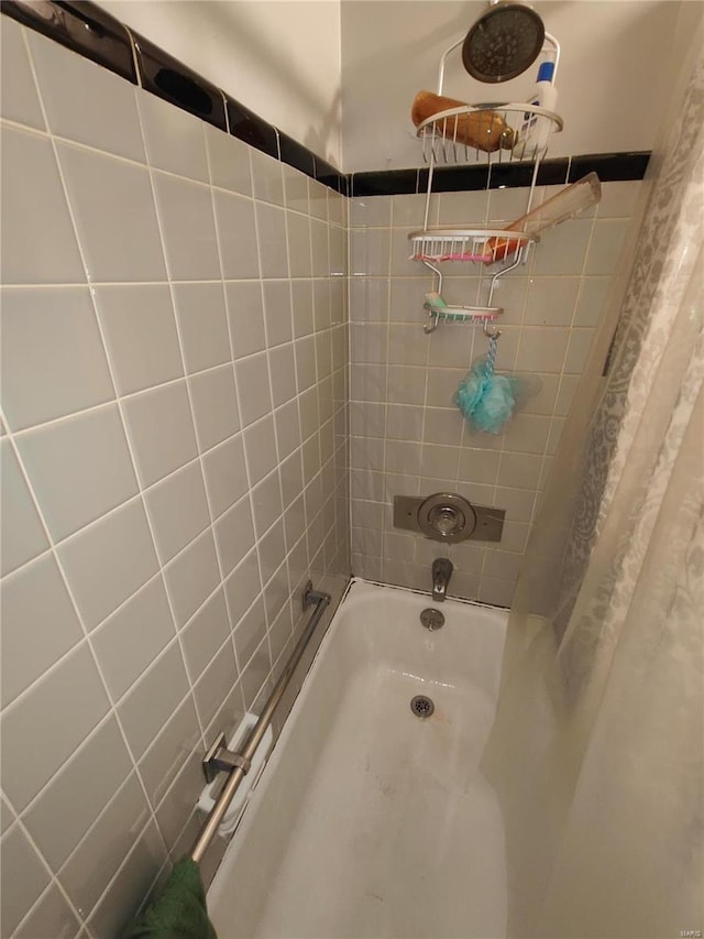 bathroom with shower / bath combo with shower curtain