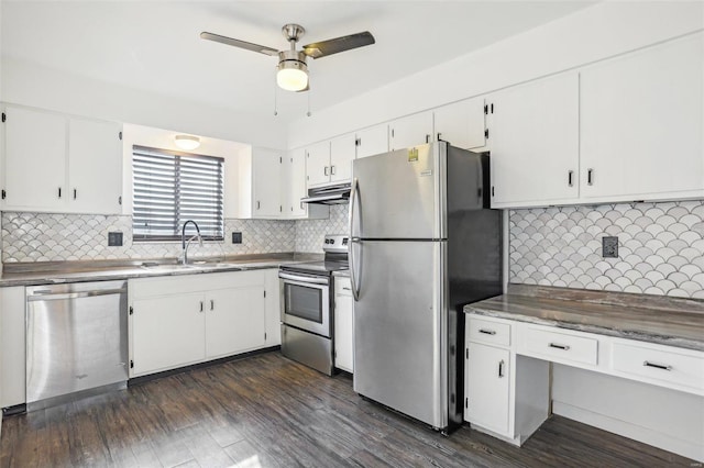 kitchen featuring under cabinet range hood, appliances with stainless steel finishes, dark wood-style floors, white cabinetry, and a sink