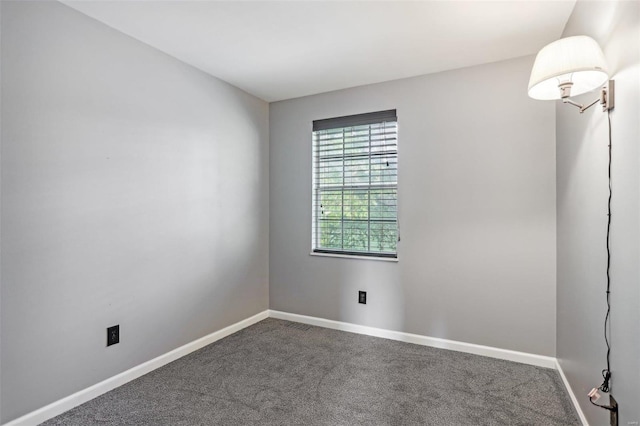 carpeted empty room with baseboards