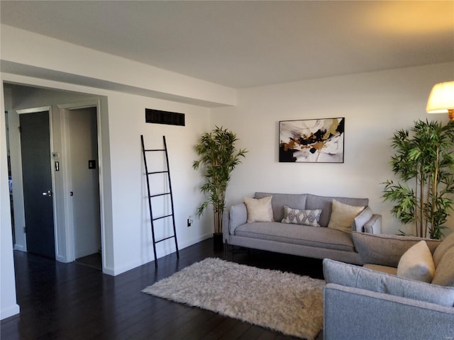 living area featuring dark wood-style floors and baseboards