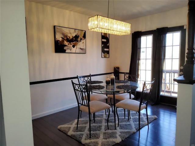 dining room with dark wood-type flooring and baseboards