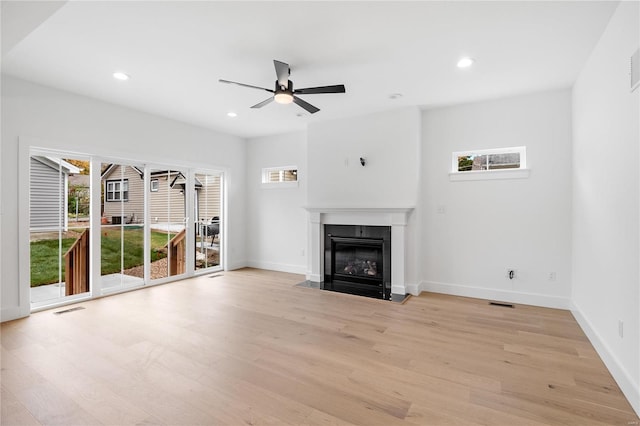 unfurnished living room featuring light hardwood / wood-style floors and ceiling fan