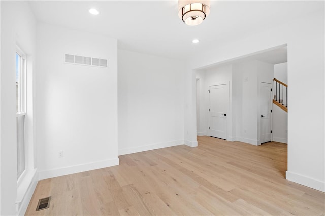 spare room featuring light hardwood / wood-style floors