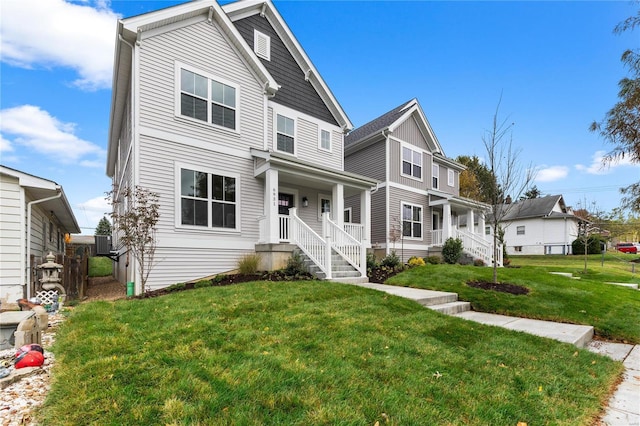 view of front of property with covered porch and a front lawn