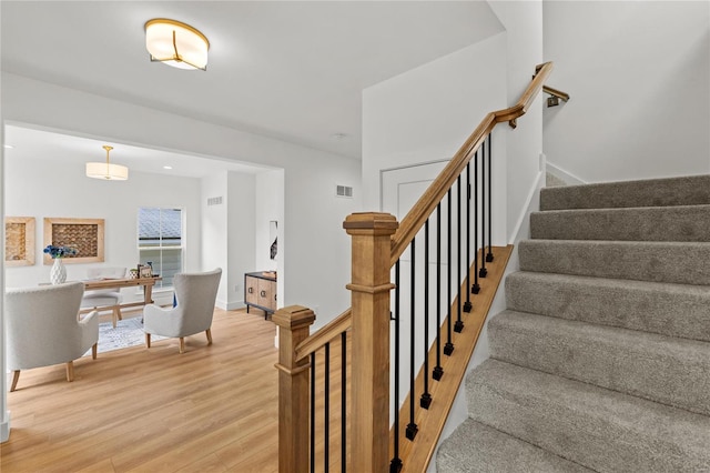 stairs featuring hardwood / wood-style flooring