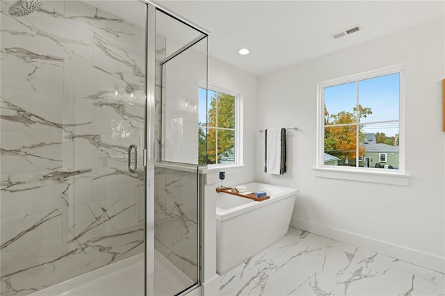 bathroom featuring shower with separate bathtub