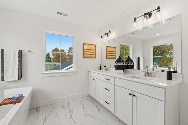 bathroom featuring a tub and vanity