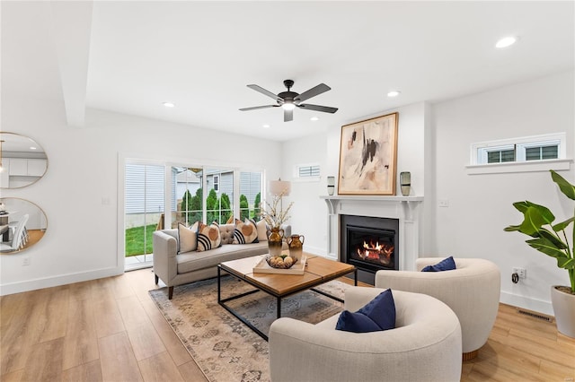 living room featuring ceiling fan and light wood-type flooring