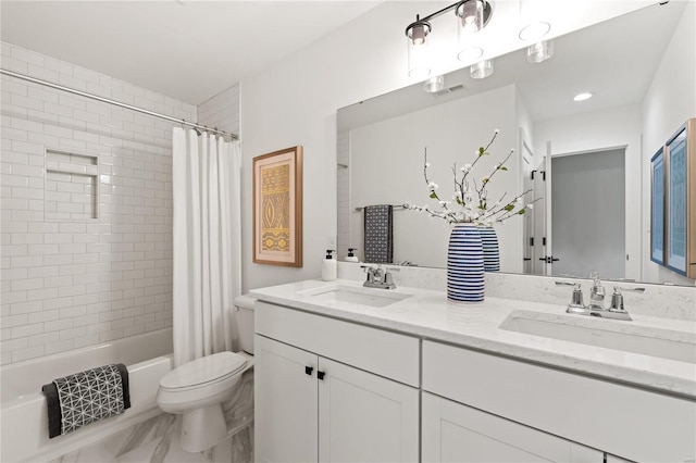 full bathroom with vanity, shower / bath combo, and toilet