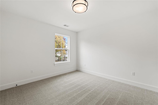 empty room featuring light carpet