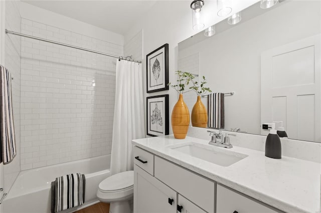 full bathroom featuring shower / bath combo with shower curtain, vanity, and toilet