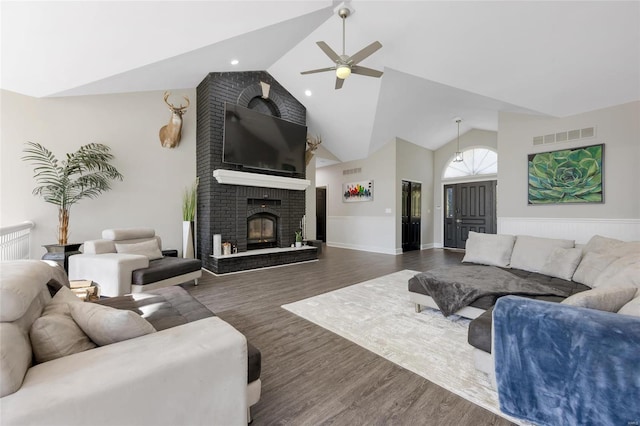 living room featuring a fireplace, ceiling fan, dark hardwood / wood-style flooring, and lofted ceiling