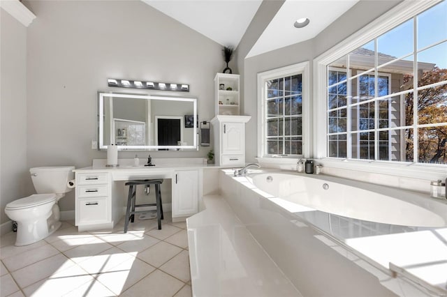 bathroom with tile patterned floors, a bathtub, vaulted ceiling, sink, and toilet