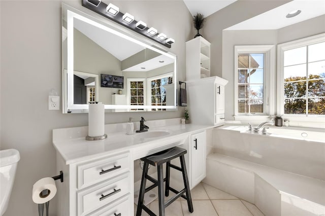 bathroom with tile patterned flooring, vanity, lofted ceiling, and toilet