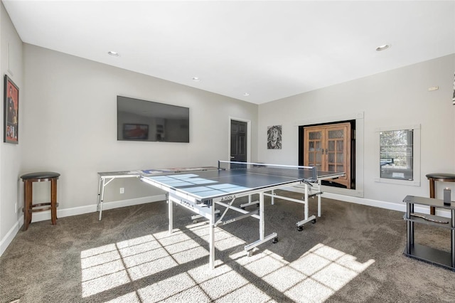 game room with dark colored carpet