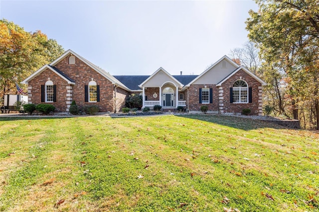 single story home with covered porch and a front yard