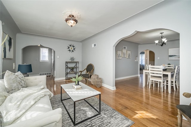 living room featuring a chandelier and hardwood / wood-style flooring