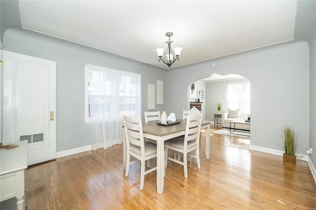 dining room featuring a notable chandelier and light hardwood / wood-style flooring