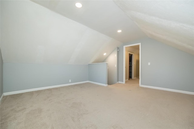 additional living space with light colored carpet and lofted ceiling