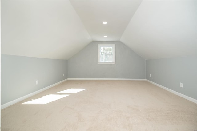 additional living space with carpet flooring and vaulted ceiling