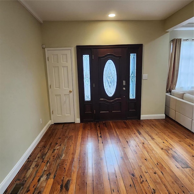 entrance foyer with hardwood / wood-style flooring and a healthy amount of sunlight