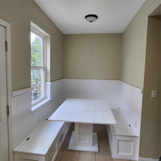 unfurnished dining area featuring light tile patterned floors