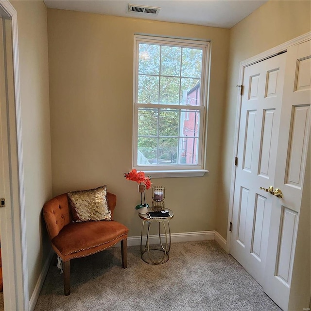 sitting room featuring light carpet