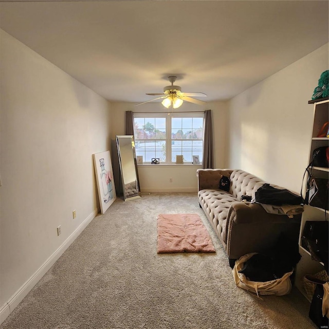 sitting room featuring ceiling fan and carpet floors