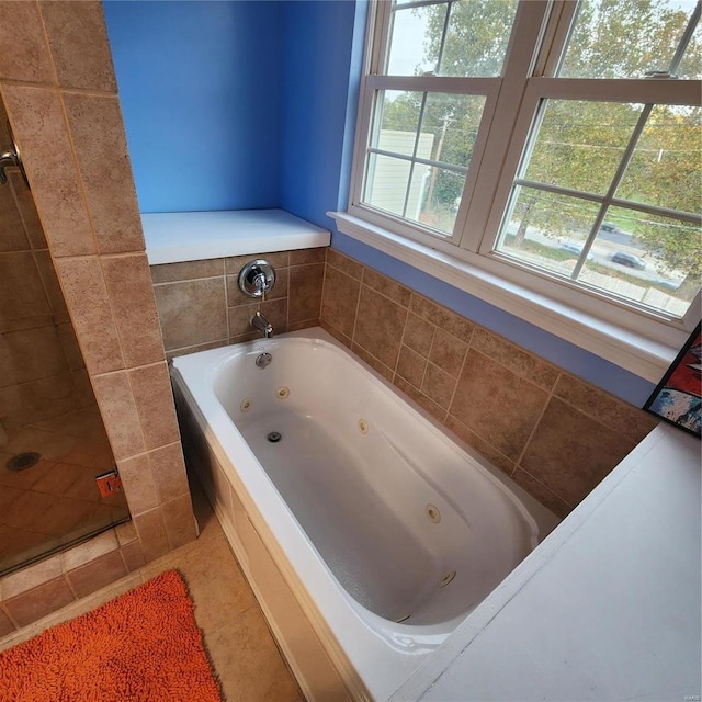 bathroom with tile patterned flooring and a bathing tub