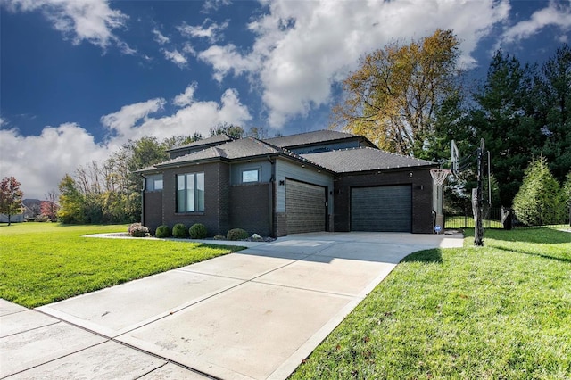 prairie-style home featuring a front lawn and a garage