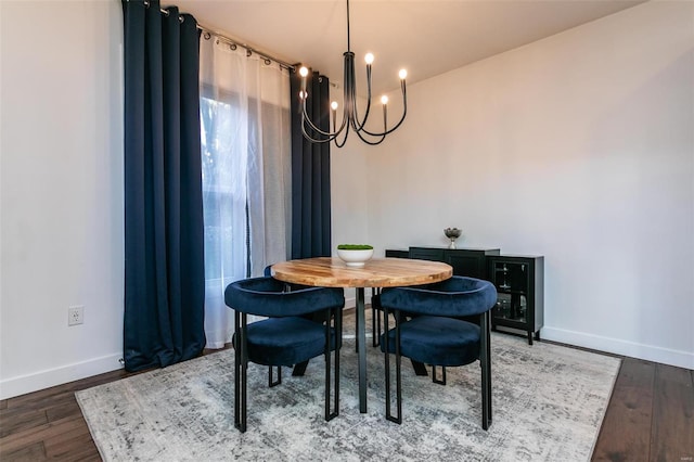 dining space featuring an inviting chandelier and dark hardwood / wood-style flooring