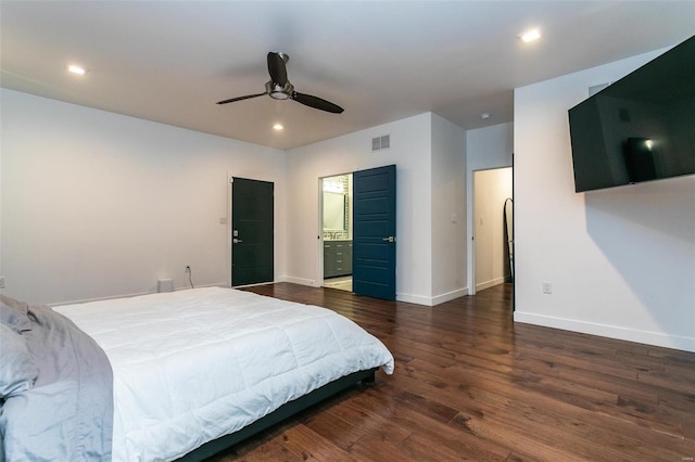 bedroom featuring dark hardwood / wood-style flooring, connected bathroom, and ceiling fan