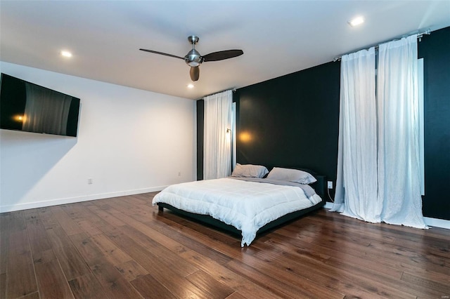 bedroom featuring ceiling fan and dark hardwood / wood-style floors