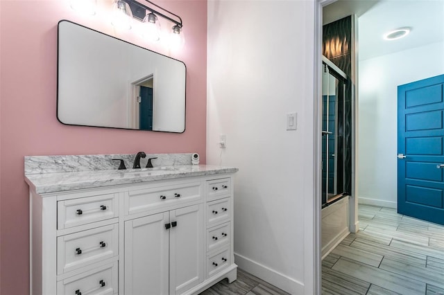 bathroom with bath / shower combo with glass door and vanity