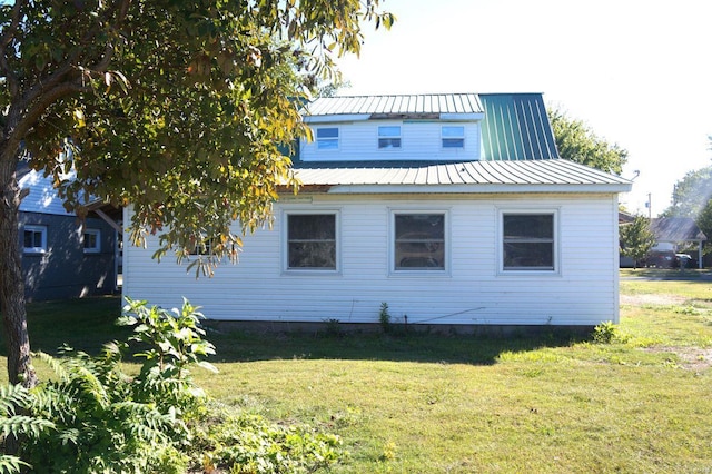 view of side of property with a yard