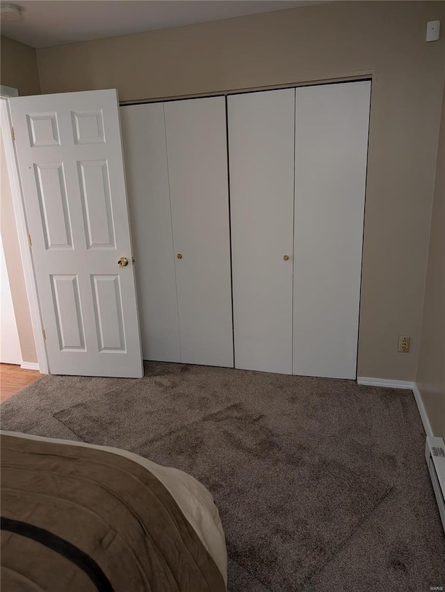 unfurnished bedroom with carpet floors and a closet