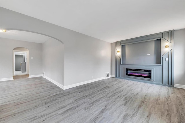 unfurnished living room with light hardwood / wood-style floors