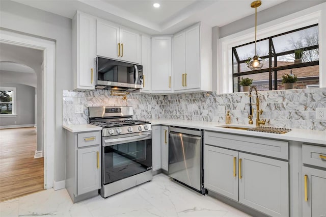 kitchen featuring gray cabinetry, plenty of natural light, stainless steel appliances, and sink