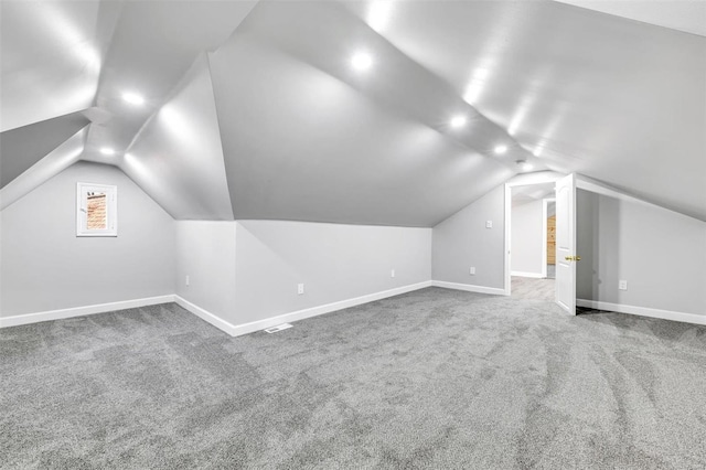 bonus room with carpet floors and vaulted ceiling